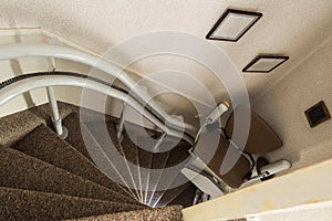 Mechanical chair lift taking disabled or aged people up and down stairs Senior, Stairlift for disabled