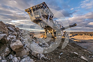 Mechanical conveyor belt to pulverize rock and stone and generate gravel photo