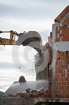 Mechanical digger demolishing a building