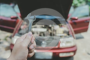 Mechanical engineer hands open the car skirt to check the oil level of the car. The concept of engine maintenance Travel safely