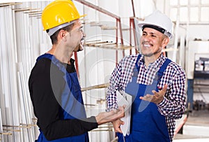 Mechanical engineer inspecting the work of labour at factory