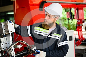 Mechanical engineer repairing engine machine at factory