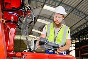 Mechanical engineer repairing engine machine at factory