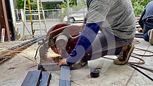 Mechanical engineer using hacksaw to cut metal frame to build the roofMechanical engineer using hacksaw to cut metal frame to buil