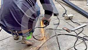 Mechanical engineer using hacksaw to cut metal frame to build the roofMechanical engineer using hacksaw to cut metal frame to buil