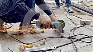 Mechanical engineer using hacksaw to cut metal frame to build the roofMechanical engineer using hacksaw to cut metal frame to buil