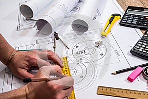 Mechanical engineer with work at technical drawings