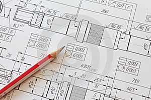 Mechanical engineering drawing with a pencil lying on it. Engineering concept