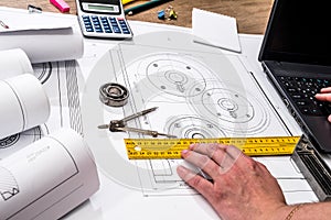 Mechanical engineering of parts with tools, laptop,