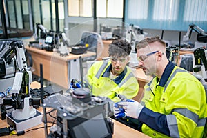 Mechanical engineering team working in robotic technology lap for research and develop for manufacturing automation and robotics