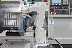 Mechanical hand robot working with CNC lathe machine