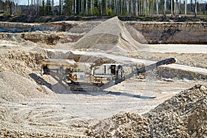 Mechanical machine, conveyor belt for transporting and crushing stone with sand. Mining quarry for the production of crushed stone