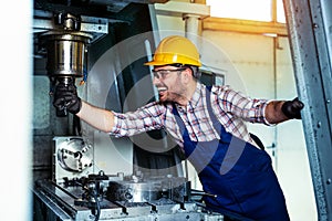 Mechanical technician worker of cnc milling cutting machine center at tool workshop manufacturing