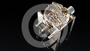 Mechanical watch movement on a watchmaker holding tool