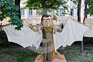 Mechanical wings of the Italian inventor Leonardo da Vinci. The girl with the mechanism of retro wings made of fabric