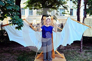 Mechanical wings of the Italian inventor Leonardo da Vinci. A woman with a mechanism of vintage wings made of fabric and wood