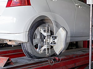 Mechanician changing car wheel in auto repair