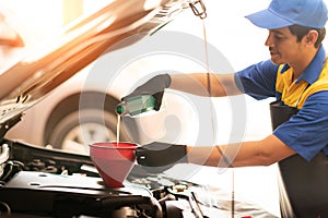 Mechanician changing car wheel in auto repair shop