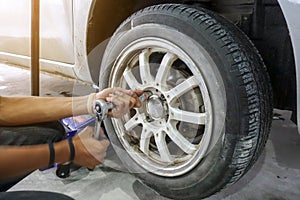 Mechanician changing car wheel photo