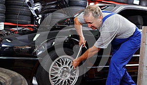 Mechanician changing car wheel photo