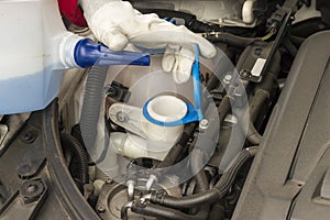 Mechanician performing maintenance on a car engine