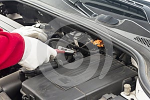 Mechanician performing maintenance on a car engine photo