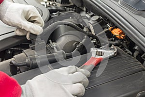 Mechanician performing maintenance on a car engine photo