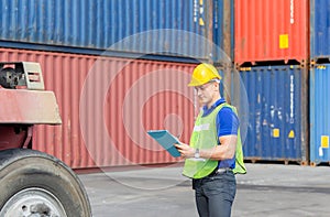 Mechanics checking wheel in cargo container. Professional technician pre-check forklift truck tires, safety concept