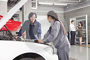 Mechanics and Customers in Auto Repair Shop