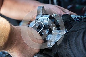 Mechanics with dirty hands repair broken starter on car/ Automotive service