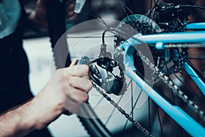 Mechanics Hand Repairing Bicycle in Bike Workshop