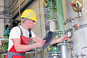 Mechanics repair and inspect an industrial plant in a modern factory