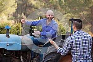 Mechanics reparing old agrimotors at farm