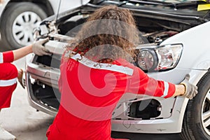 Mechanics team in uniform are working in auto service, Technician checking modern car at garage, Car repair and maintenance