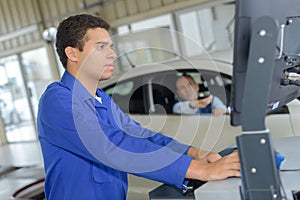 Mechanics working in vehicle test station