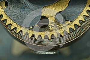 mechanism of an old clock made of yellow dirty copper springs and gears