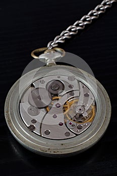 Mechanism of old pocket watch on a black background