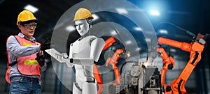 Mechanized industry robot and human worker working together in future factory