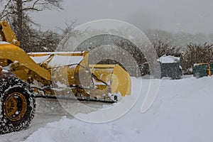 Mechanized tractor for snow removal is parked on a city street after snowfall