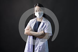 Med student or resident doctors wear face mask standing on black background.