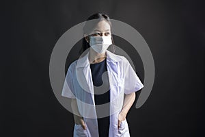 Med student or resident doctors wear face mask standing on black background.