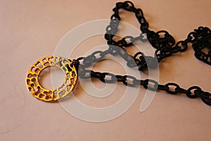 Medal pendant with black plastic chain