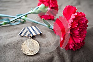 Medal For Victory over Germany in the Great Patriotic War of 1941-1945 and two red carnations