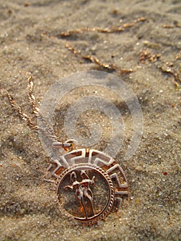 Medallion on sand.