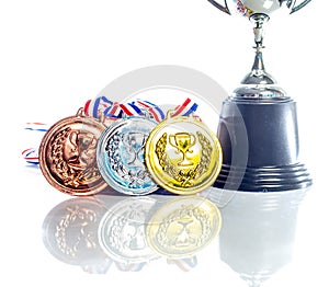 Medals - gold, silver and bronze isolated on white. Reflected. Shallow depth of field