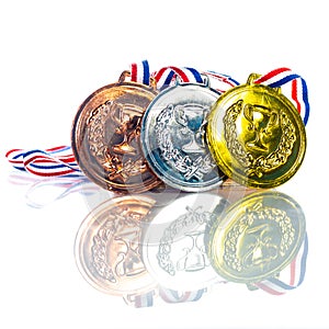 Medals - gold, silver and bronze isolated on white. Reflected. Shallow depth of field
