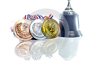 Medals - gold, silver and bronze isolated on white. Reflected. Shallow depth of field