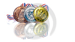 Medals - gold, silver and bronze isolated on white. Reflected. Shallow depth of field