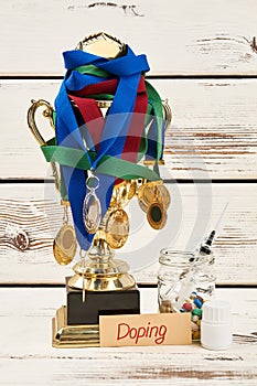 Medals, trophy and doping drugs photo