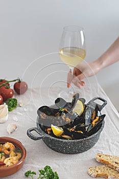 Medditeranean lunch, fresh cooked mussels with tomato, parsley, lemon, fresh bread and white wine